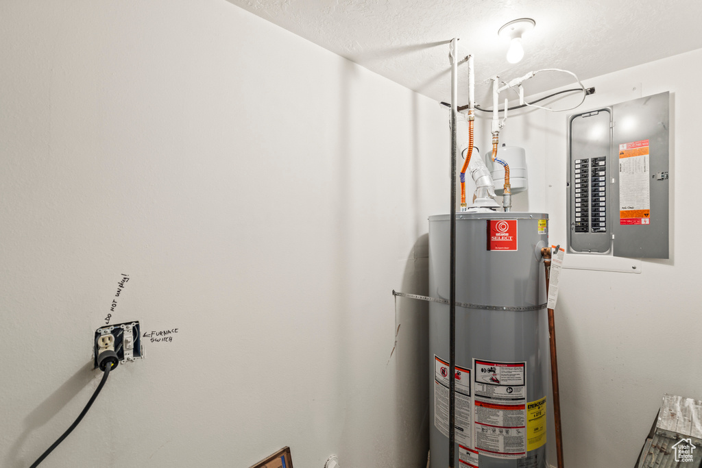 Utility room with electric panel and water heater