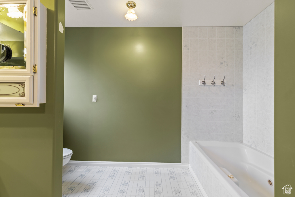 Bathroom with toilet and baseboards