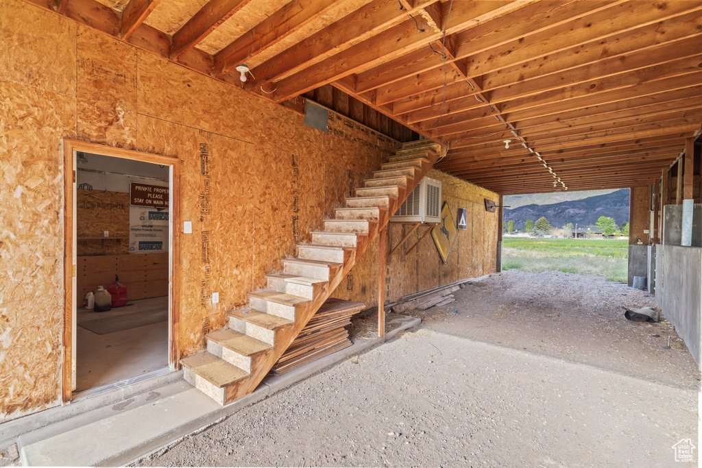 Stairs with a mountain view and a wall unit AC