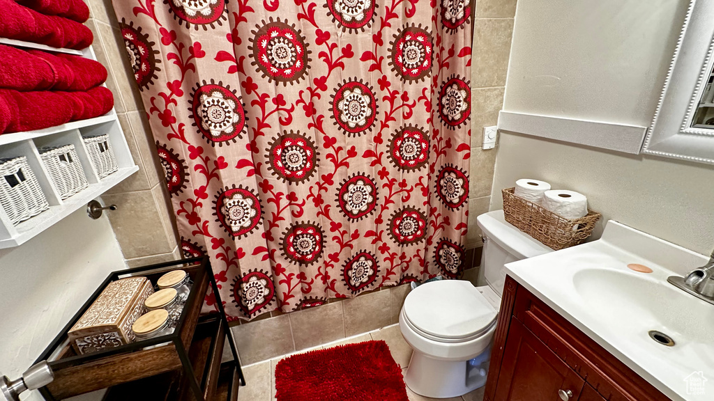 Full bath with vanity, a shower with shower curtain, toilet, and tile patterned floors