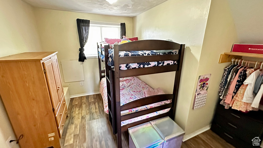 Bedroom featuring wood finished floors and baseboards