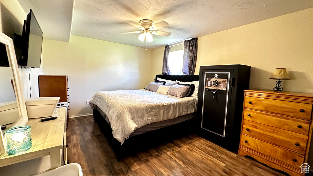 Bedroom featuring dark wood-style flooring and ceiling fan