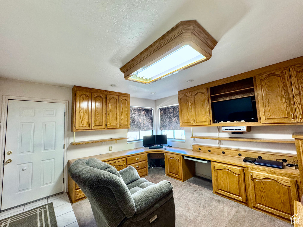 Kitchen featuring brown cabinets, open shelves, and light countertops