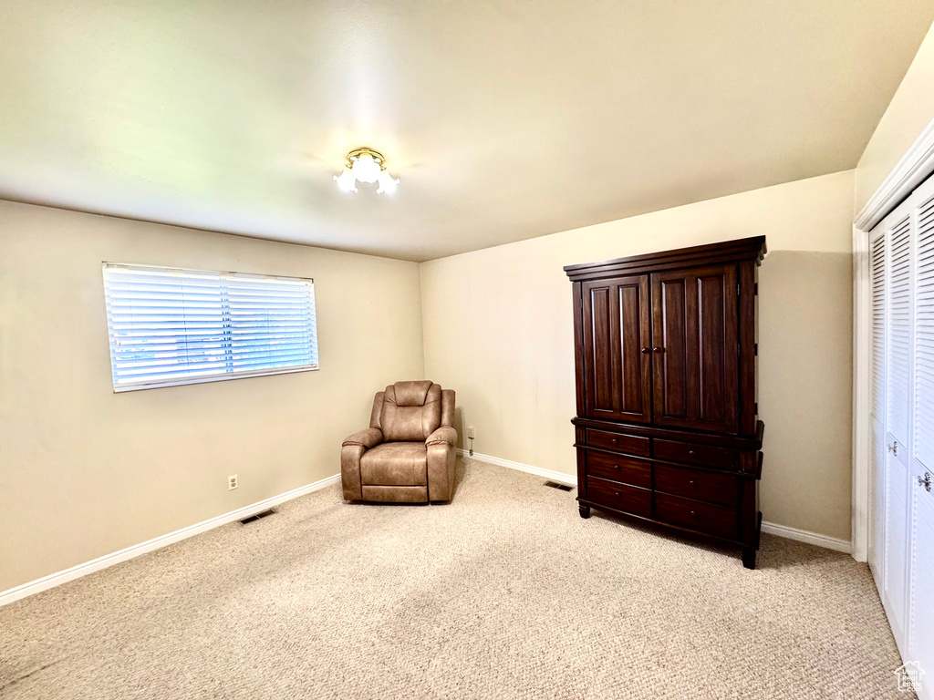 Sitting room featuring light colored carpet and baseboards