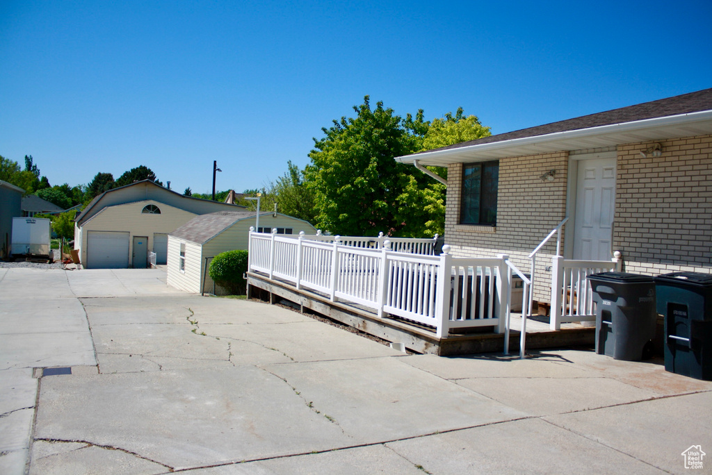 View of patio with a garage and a wooden deck