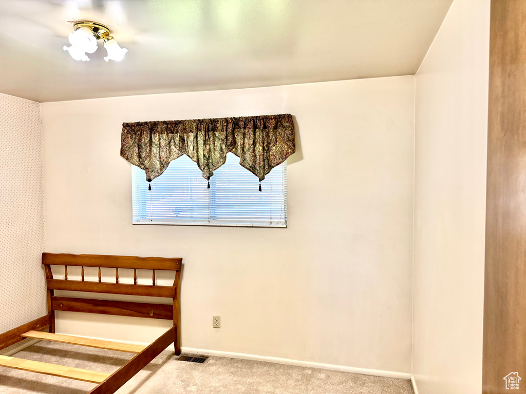 Unfurnished bedroom featuring carpet floors and baseboards