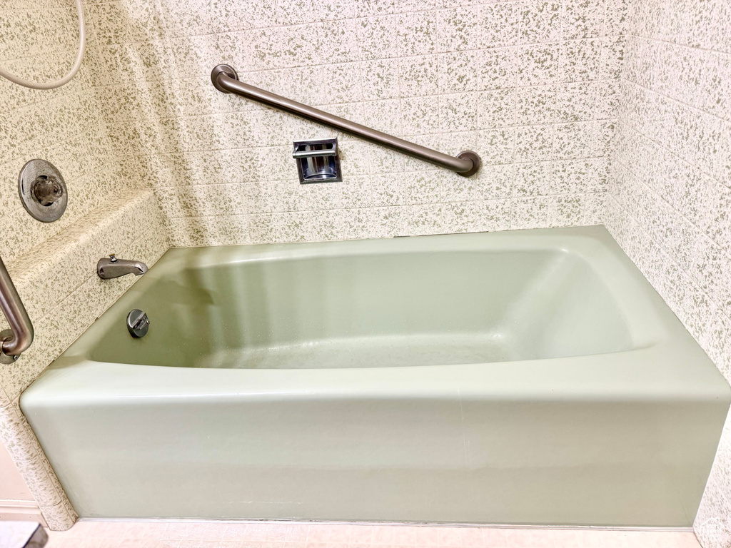 Bathroom with a tub and a sink