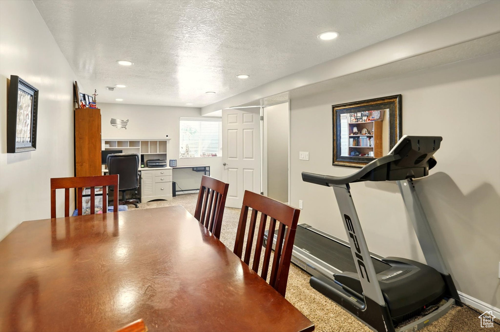 Workout room with a textured ceiling, recessed lighting, and baseboards