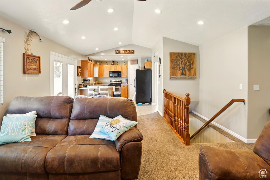 Living room featuring vaulted ceiling, a ceiling fan, recessed lighting, light carpet, and baseboards