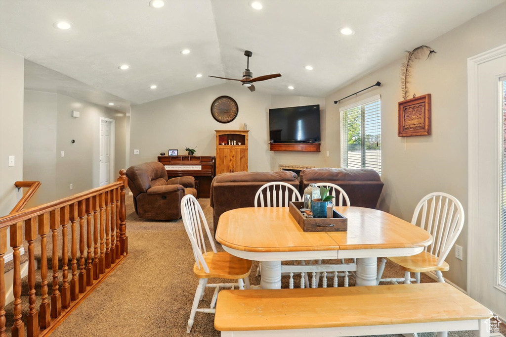 Carpeted dining space with a ceiling fan, lofted ceiling, and recessed lighting