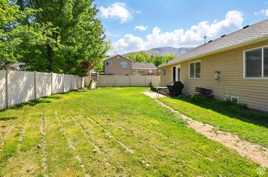 View of yard with a mountain view and a patio area