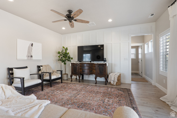 Living room featuring wood finished floors, ceiling fan, recessed lighting, and baseboards