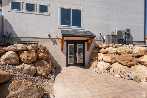 Property entrance featuring central air condition unit