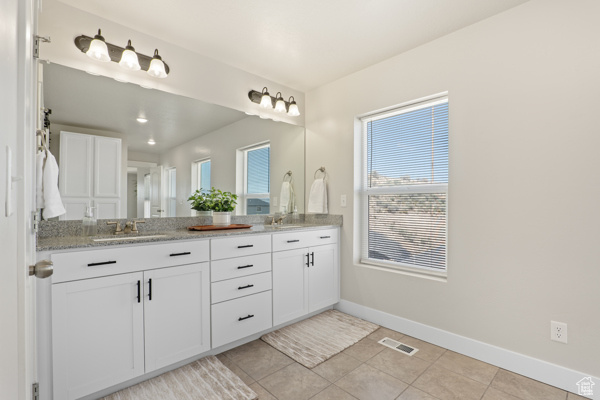 Full bath with baseboards, tile patterned flooring, double vanity, and recessed lighting