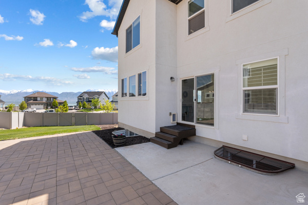 View of patio with fence, a mountain view, and a residential view