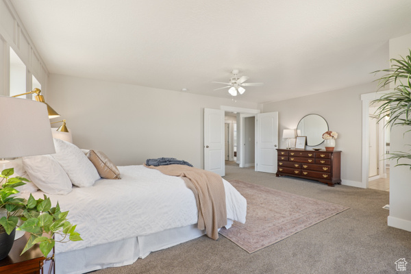 Bedroom featuring carpet, a ceiling fan, and baseboards
