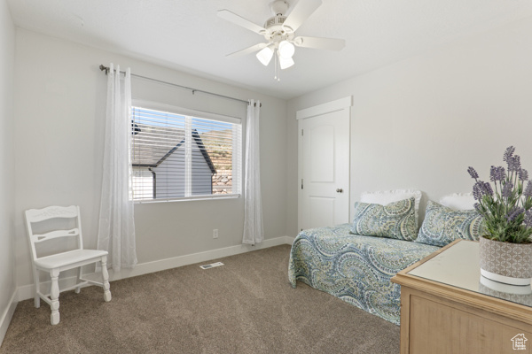 Bedroom featuring carpet flooring, baseboards, and a ceiling fan