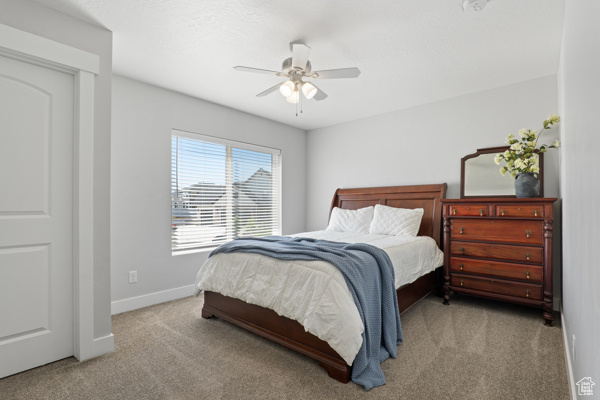 Bedroom featuring carpet, baseboards, and a ceiling fan
