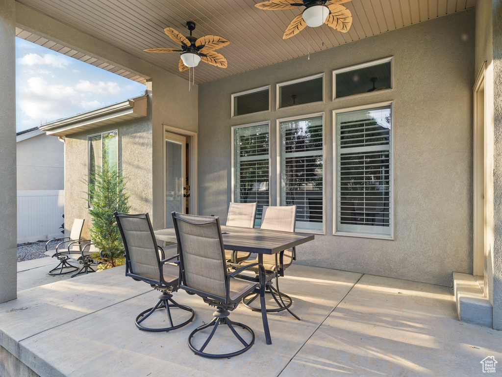 View of patio featuring a ceiling fan and outdoor dining area