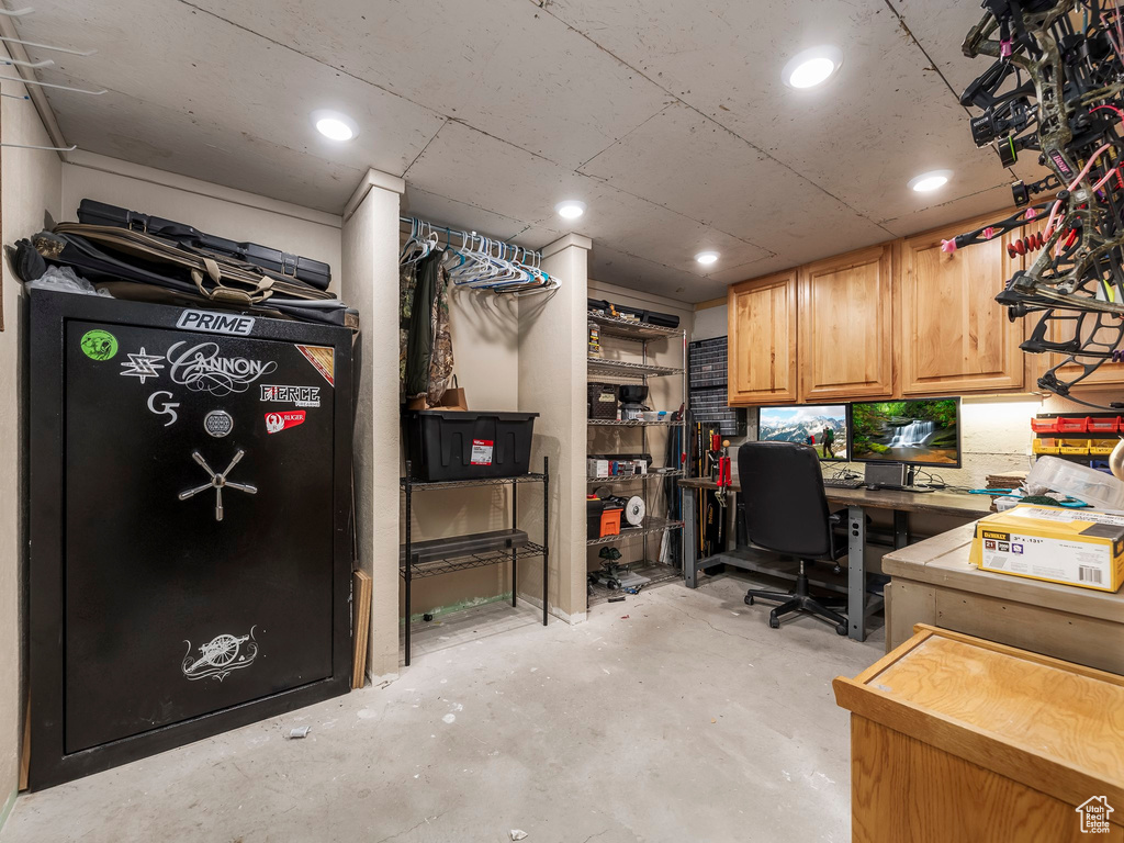 Office area with unfinished concrete flooring and recessed lighting