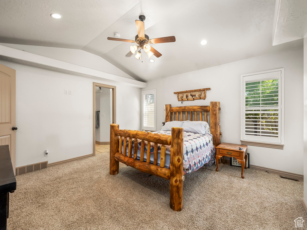 Bedroom featuring lofted ceiling, light colored carpet, baseboards, recessed lighting, and ceiling fan