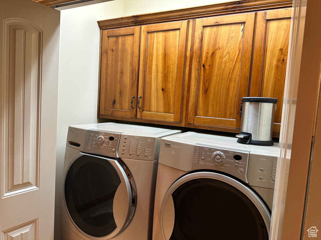 Washroom with washing machine and dryer and cabinet space