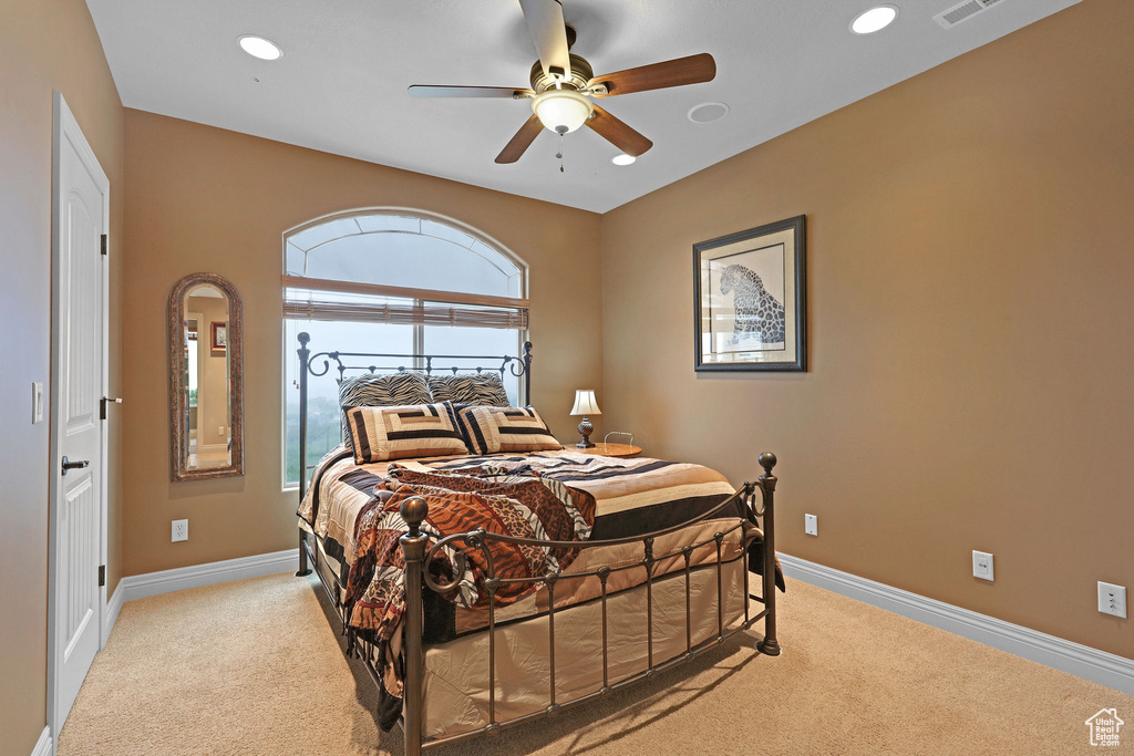 Bedroom featuring light colored carpet, baseboards, recessed lighting, and a ceiling fan