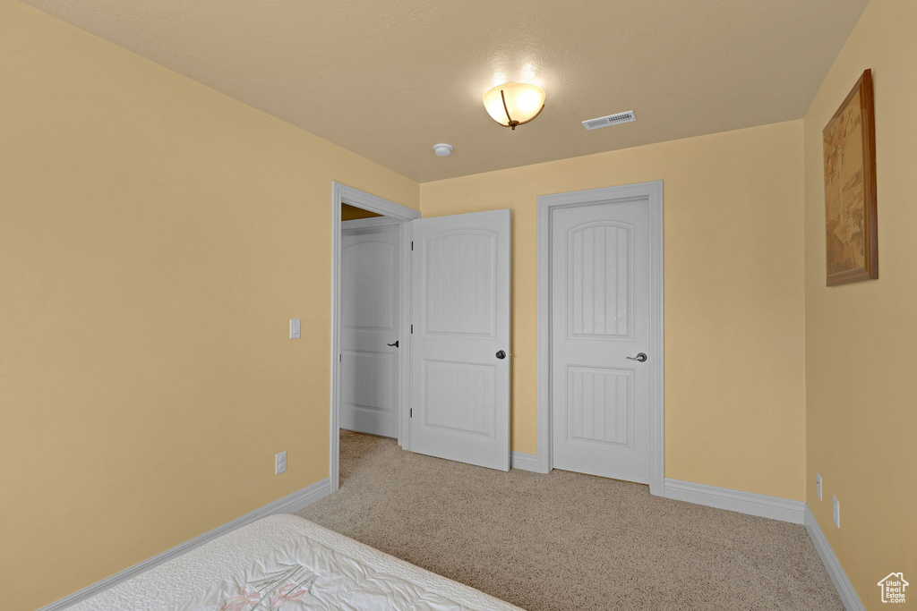 Unfurnished bedroom featuring carpet flooring and baseboards