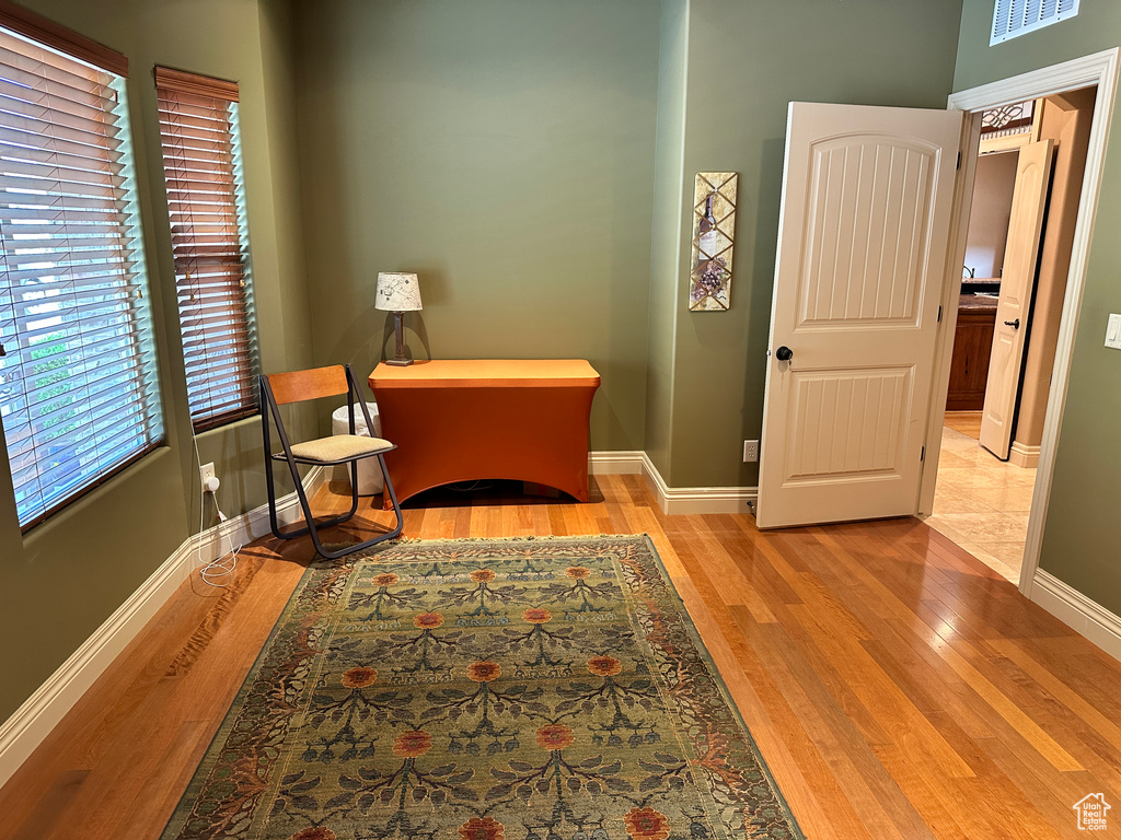 Living area with baseboards and light wood-style flooring