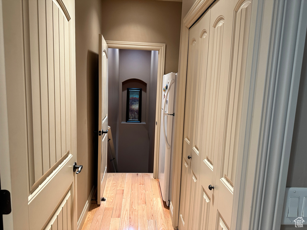 Hallway with light wood-style flooring