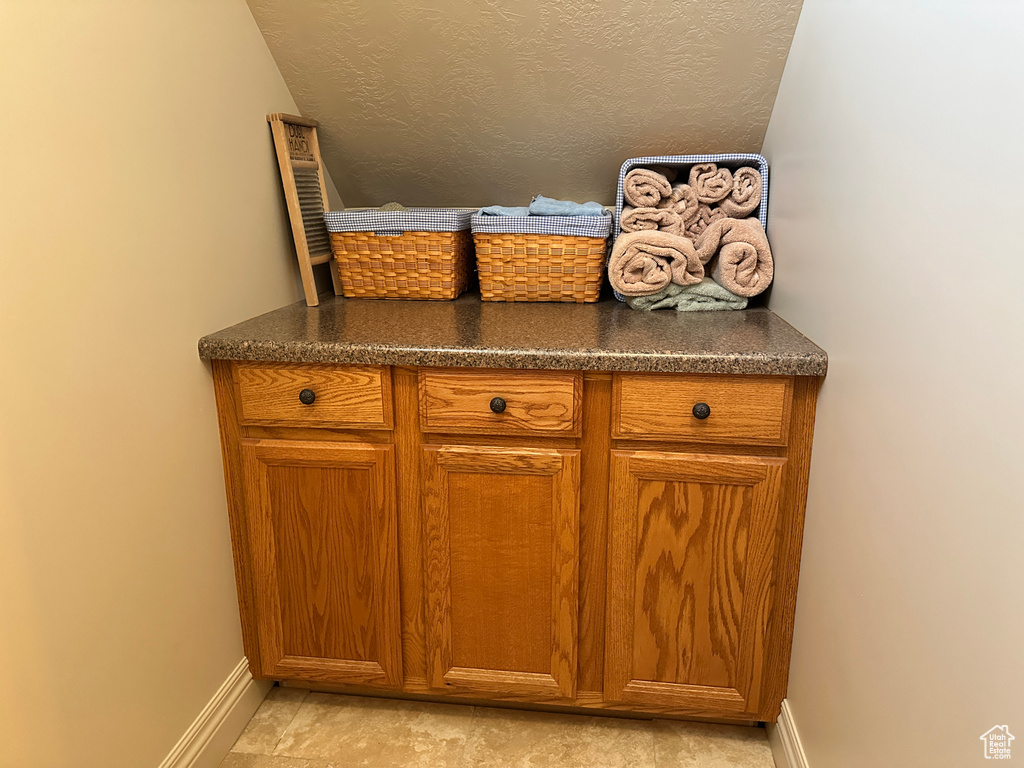 Bar area with baseboards and a textured ceiling