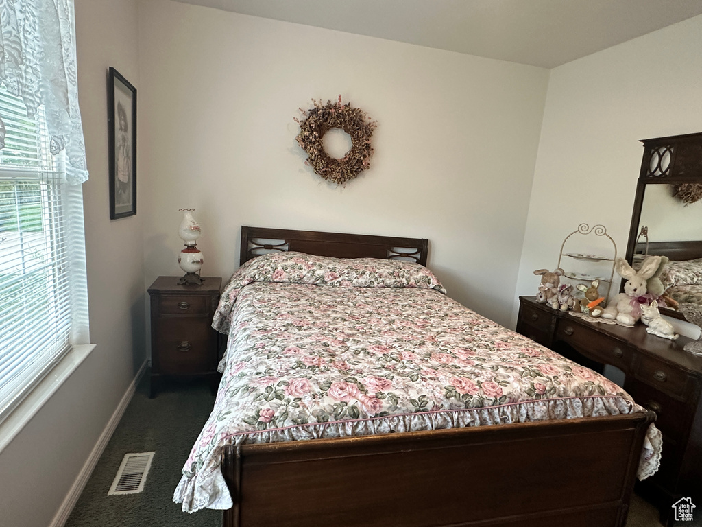 Bedroom featuring carpet floors and baseboards