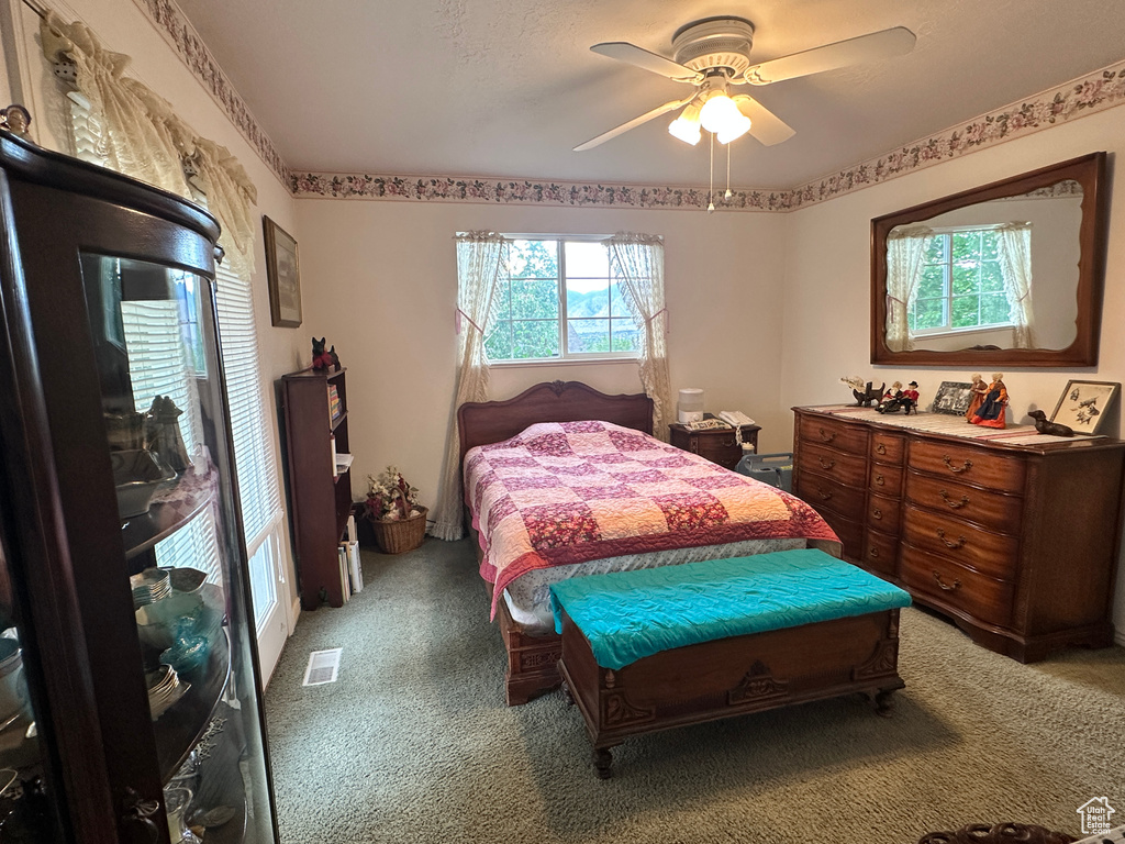 Bedroom featuring light colored carpet and a ceiling fan