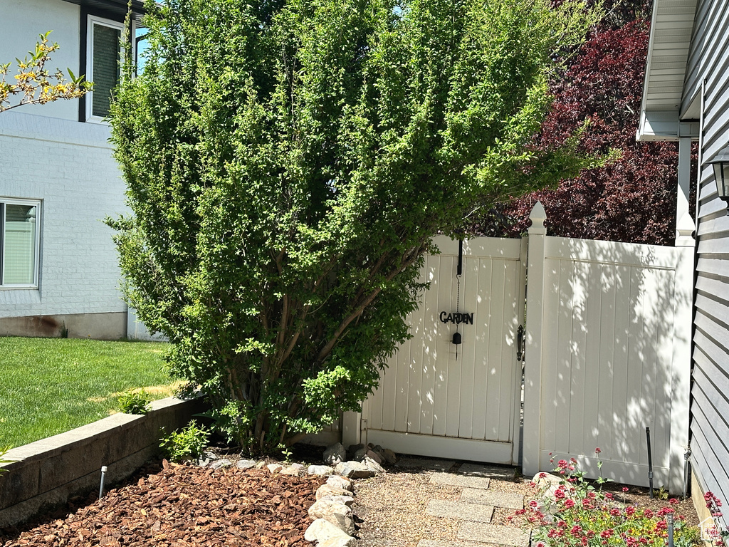 View of side of property with fence and a gate