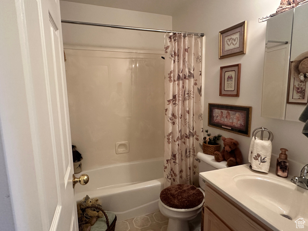 Full bath with toilet, shower / tub combo, and vanity