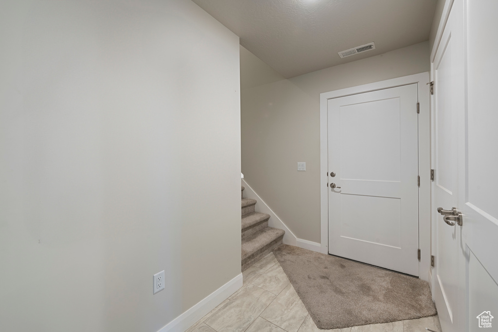 Foyer entrance featuring baseboards and stairway