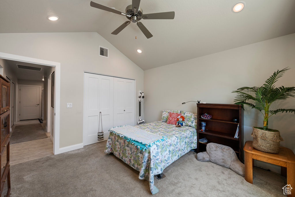 Carpeted bedroom featuring recessed lighting, high vaulted ceiling, a closet, baseboards, and ceiling fan