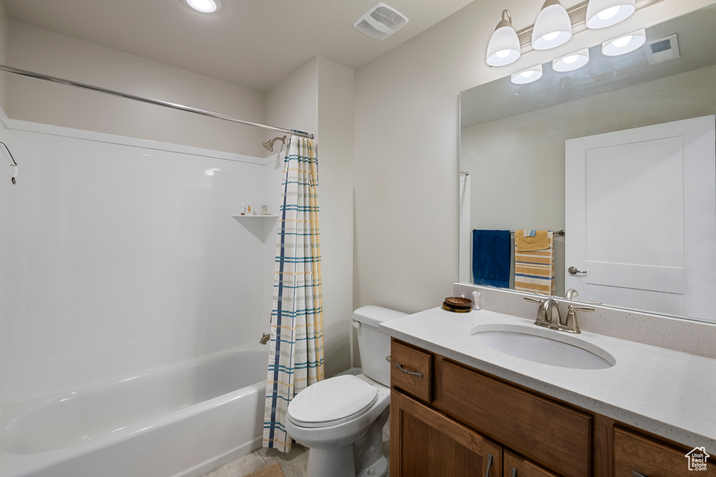 Full bath with toilet, vanity, shower / tub combo, and tile patterned floors