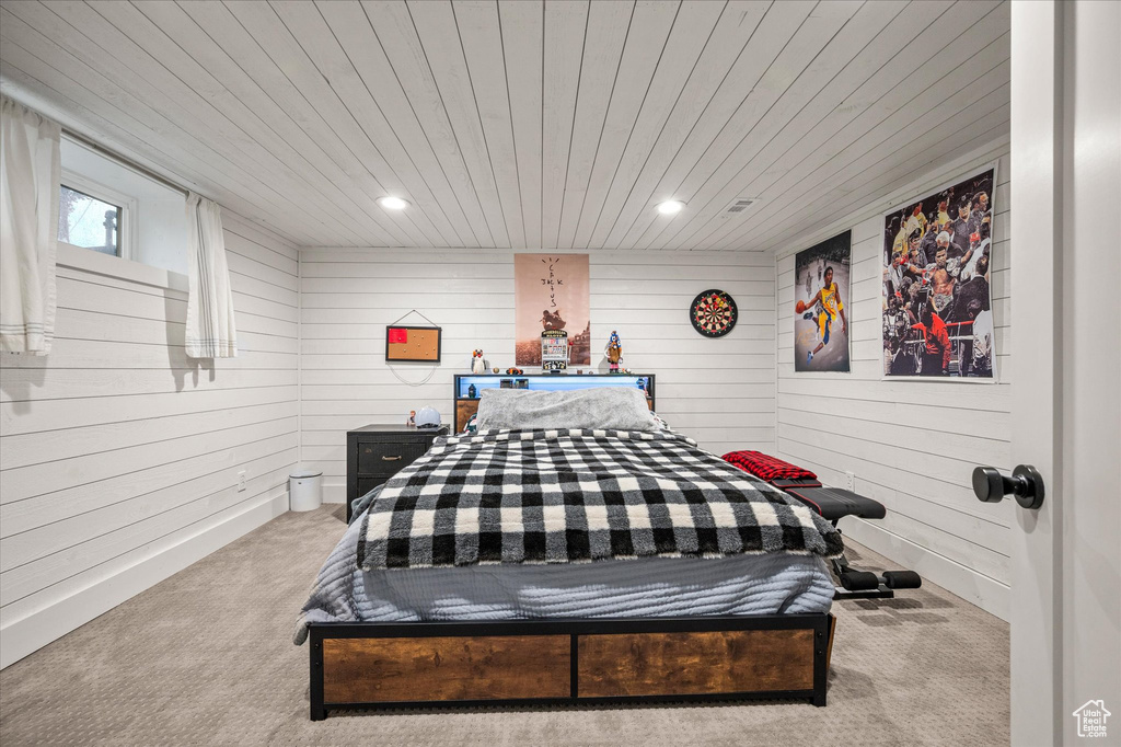 Bedroom featuring carpet, wooden walls, wooden ceiling, and recessed lighting