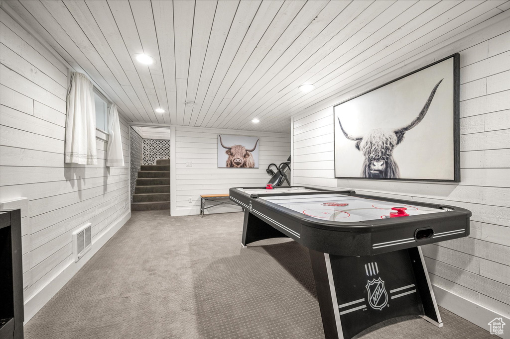 Recreation room with wooden walls, carpet, recessed lighting, and wood ceiling