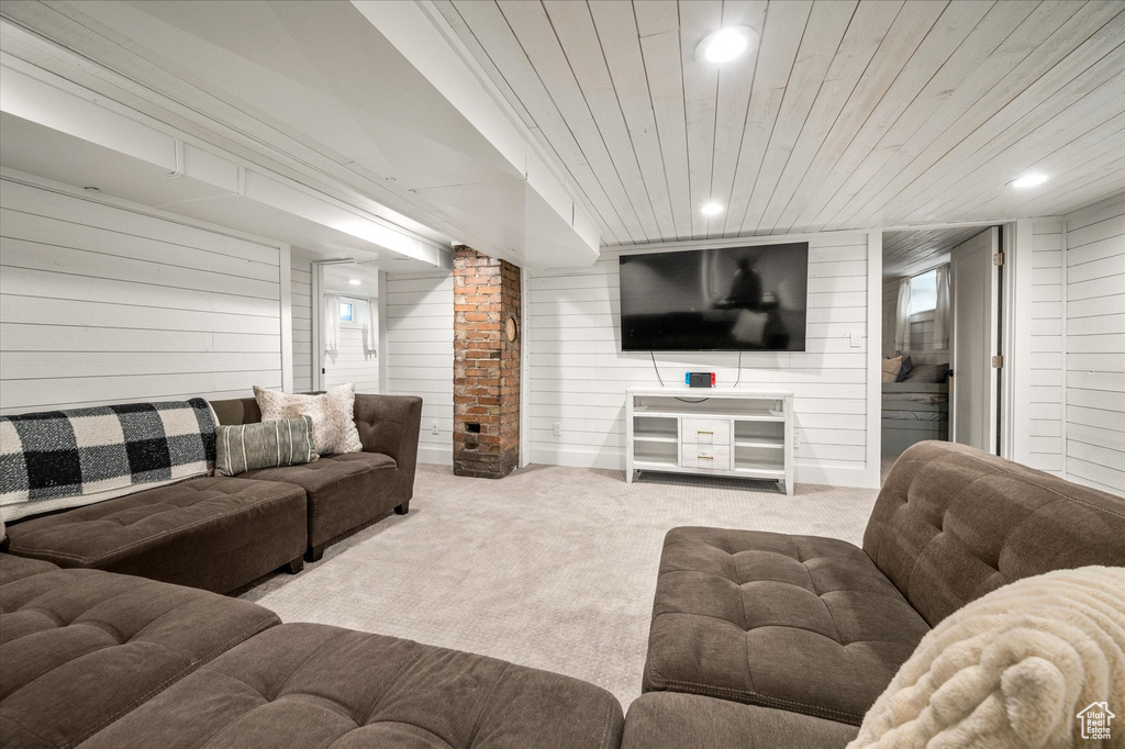 Living room with carpet floors, wooden walls, recessed lighting, and wooden ceiling