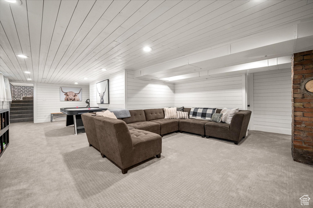 Living area with carpet floors, wooden ceiling, wood walls, recessed lighting, and billiards table