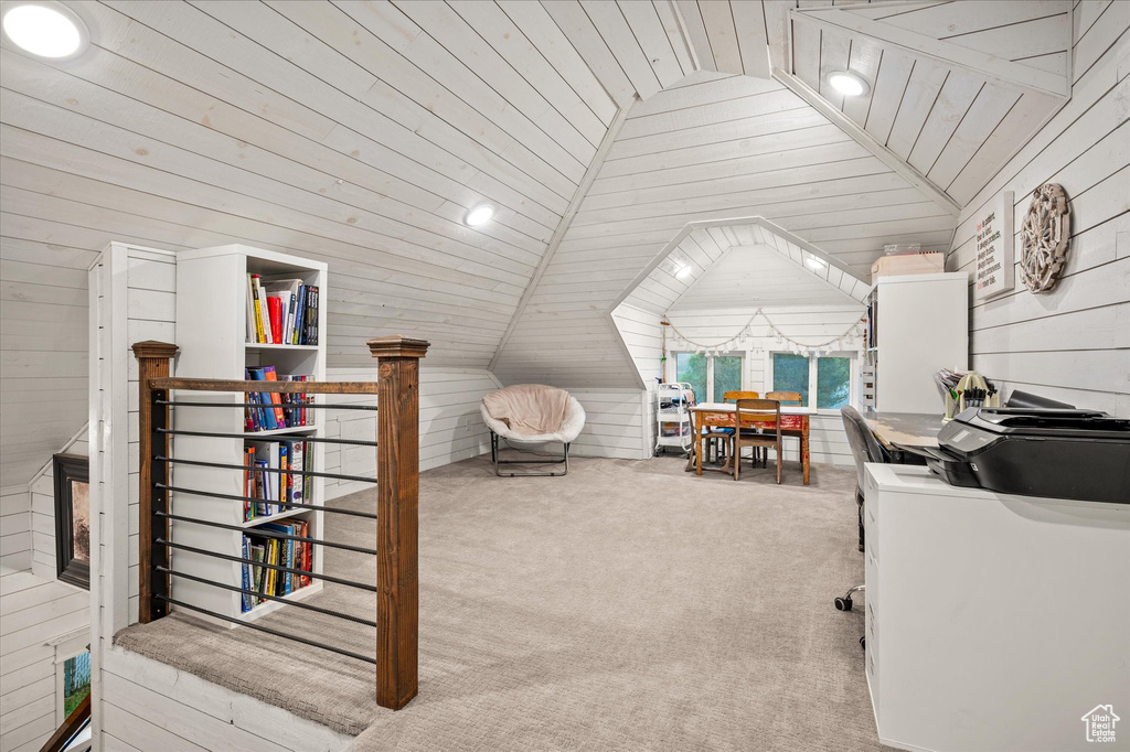 Bedroom featuring lofted ceiling, wooden walls, carpet floors, and wooden ceiling