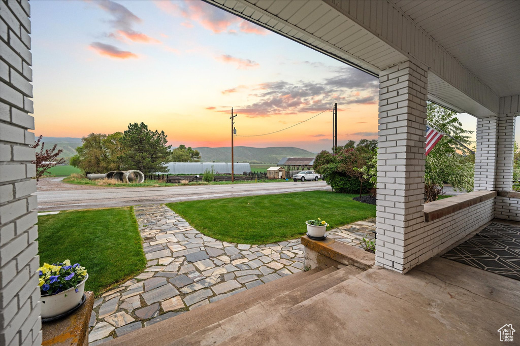 Patio terrace at dusk with a yard
