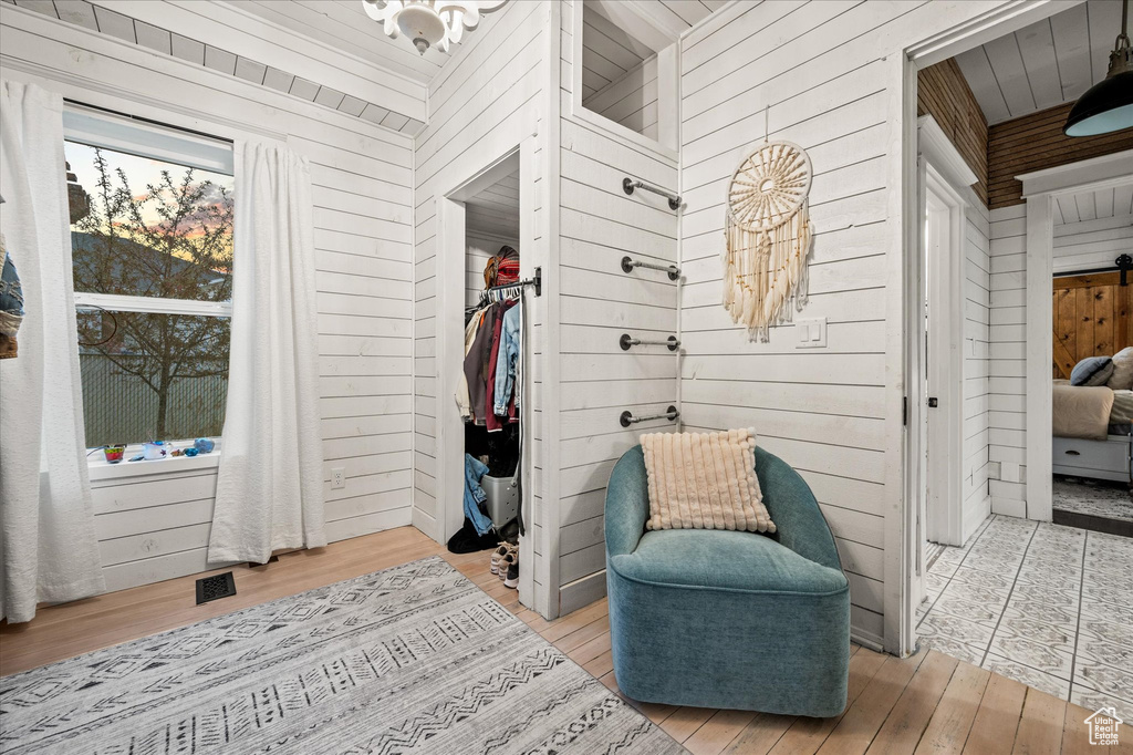 Mudroom with wooden walls and wood finished floors