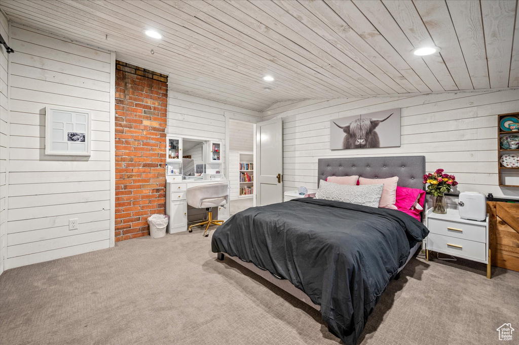 Carpeted bedroom with wooden ceiling, wooden walls, recessed lighting, and a desk