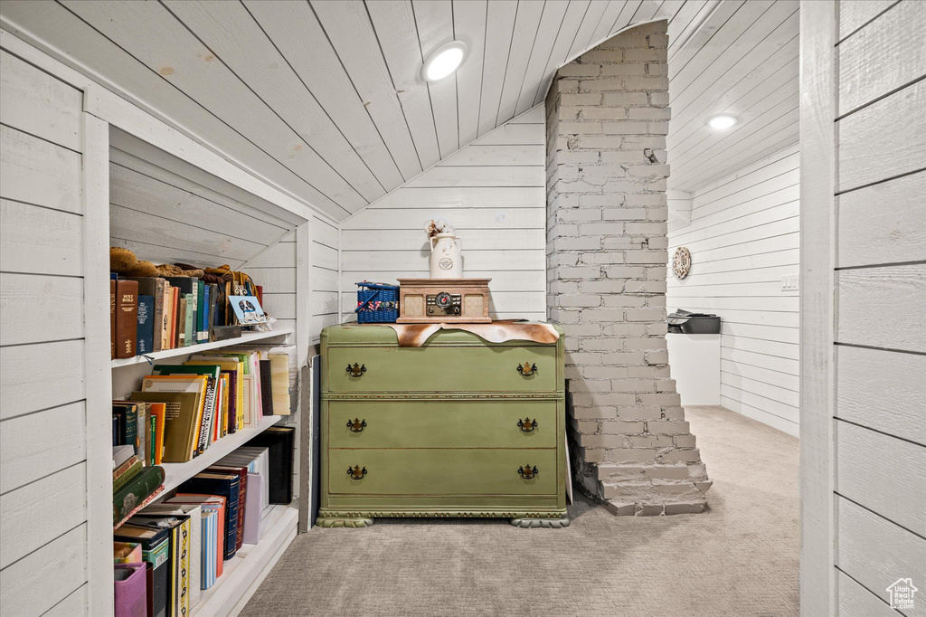 Interior space with carpet flooring, wood walls, recessed lighting, and wooden ceiling