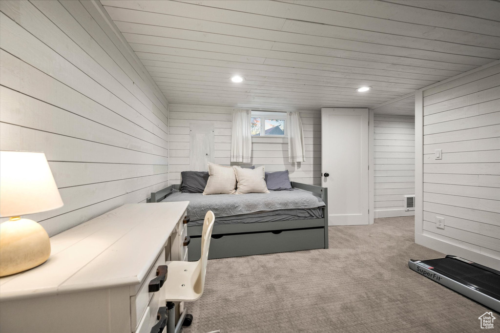 Bedroom with light carpet, wood walls, recessed lighting, and wood ceiling