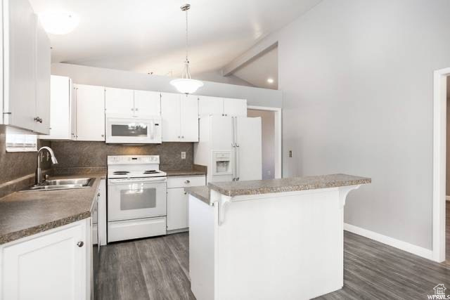 Kitchen with white appliances, a sink, dark wood-style flooring, decorative backsplash, and a center island