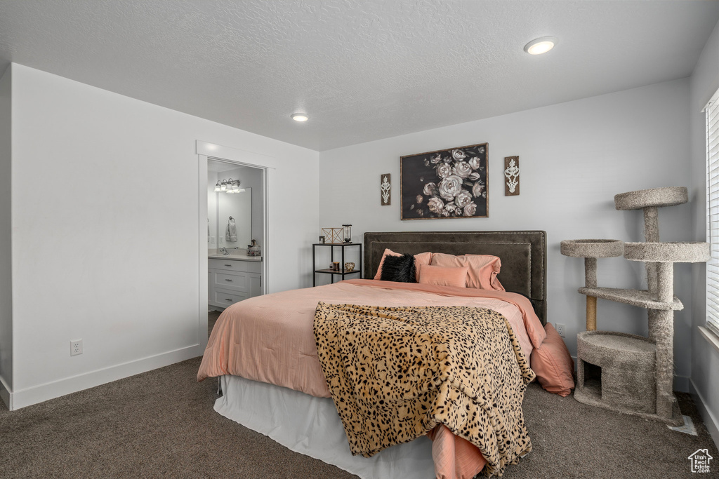 Bedroom featuring carpet flooring, baseboards, a textured ceiling, ensuite bathroom, and recessed lighting